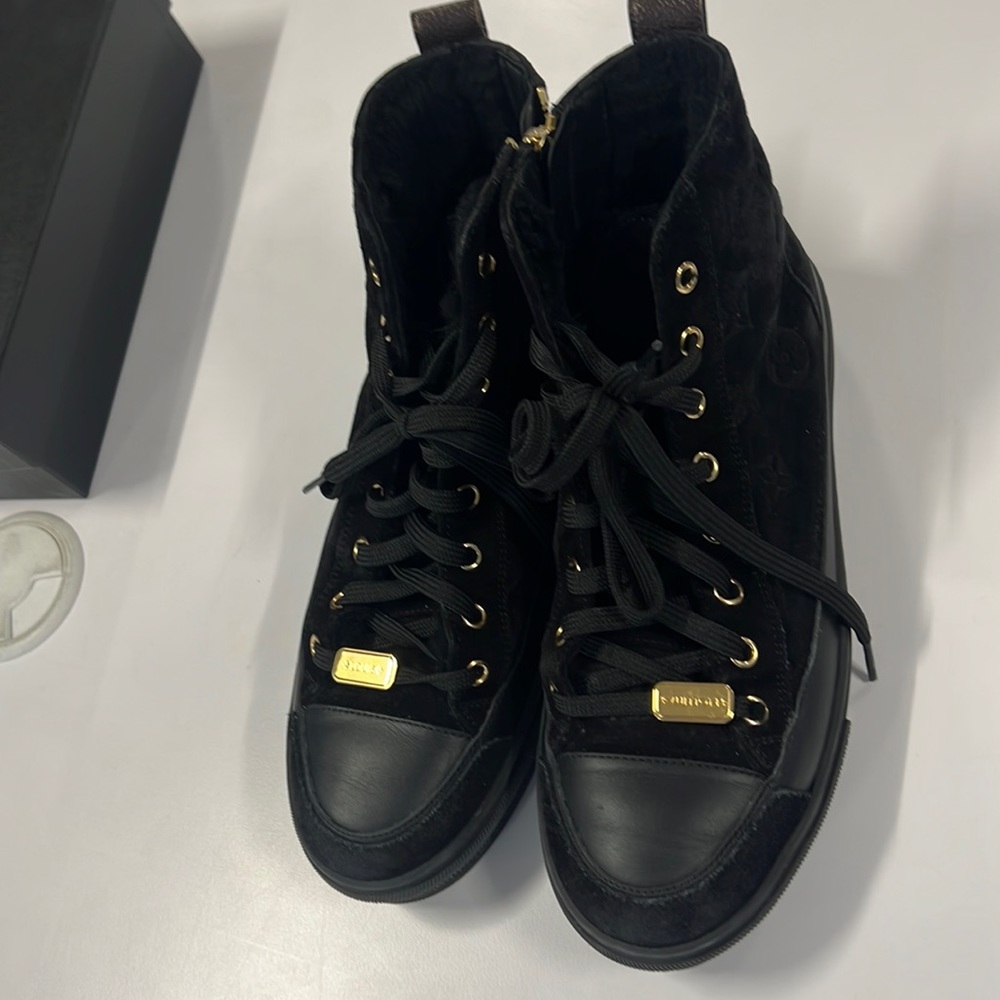 Louis Vuitton Suede Shearling lined high top sneakers.